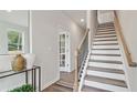 Entryway featuring wood and white stairs, offering a clean, contemporary aesthetic with an abundance of natural light at 1305 Lakota Pl, Atlanta, GA 30315
