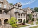 View of a neighborhood featuring brick homes with covered porches and well-maintained lawns at 2110 Timball Nw Rd, Atlanta, GA 30318