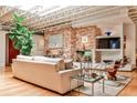 Stylish living area featuring a brick fireplace, hardwood floors, and ample natural light from large windows at 1933 Mclendon Ne Ave # A, Atlanta, GA 30307