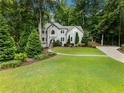 Beautiful home with lush greenery, expansive lawn, and charming architectural details on a sprawling lot at 1975 River Forest Drive, Marietta, GA 30068