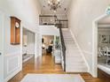 Elegant foyer with hardwood floors, staircase with iron railing, and a soaring ceiling with chandelier at 1975 River Forest Drive, Marietta, GA 30068