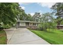 Charming one-story home features a long driveway and well-maintained front yard with mature landscaping at 1977 Wee Kirk Se Rd, Atlanta, GA 30316