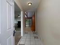 Inviting foyer features tiled flooring, neutral walls, and a glimpse into the spacious living area with lots of light at 4135 Sunrise Trail, Atlanta, GA 30349