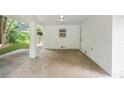 Covered car port featuring painted brick, concrete flooring, and ample open space at 4188 Fontana Ct, Tucker, GA 30084