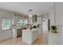 Updated kitchen with white cabinets, island, stainless steel appliances, and an open layout perfect for entertaining at 1095 Lyndhurst Way, Roswell, GA 30075