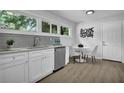 Well-lit kitchen with stainless steel appliances, white cabinetry, and an adjacent dining area at 2991 Catalina Dr, Decatur, GA 30032