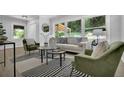 Bright living room featuring neutral-toned walls, large windows, and stylish modern furniture at 2991 Catalina Dr, Decatur, GA 30032