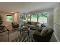 Bright living room with large windows overlooking greenery, modern furniture, and stylish decor at 2991 Catalina Dr, Decatur, GA 30032