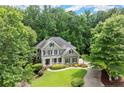 Beautiful home with landscaped front yard, porch and surrounded by lush green trees at 2015 Samuel Close Ct, Alpharetta, GA 30009