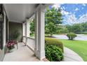 Inviting front porch features white columns, fresh flowers and view of manicured lawn at 2015 Samuel Close Ct, Alpharetta, GA 30009