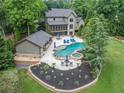 This backyard boasts a pool, spa, and an outdoor kitchen, perfect for entertaining at 407 Maple Ridge Ct, Cumming, GA 30028