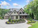 Stunning two-story home with a spacious driveway and professionally landscaped front yard at 407 Maple Ridge Ct, Cumming, GA 30028