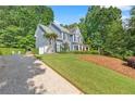 Charming two-story home with blue siding, two car garage and manicured lawn at 1945 Barrett Dr, Cumming, GA 30040