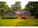 Rear exterior view features a wooden deck, and solar panels at 20 Lisa Ct, Stockbridge, GA 30281