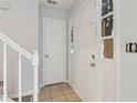 Bright entryway featuring tile flooring, a staircase, and a solid front door with glass panels at 310 Wolf Downs Way, Atlanta, GA 30349