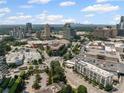 An aerial view capturing the surrounding city, including a shopping center, streets, and an assortment of buildings at 3630 Peachtree Ne Rd # 2408, Atlanta, GA 30326