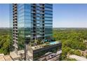 Exterior view featuring the building's terrace with a serene pool and lush green trees in the background at 3630 Peachtree Ne Rd # 2408, Atlanta, GA 30326