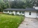 One-story home with a dark roof, white exterior and an ample lawn at 3785 Somerset Sw Dr, Marietta, GA 30064