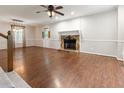 Spacious living room with hardwood floors, a stone fireplace, and a ceiling fan at 233 Oakridge Se Dr, Cartersville, GA 30121