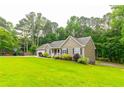 Attractive single story house features well-kept lawn and an attached two car garage at 2430 Tribble Creek Cv, Grayson, GA 30017
