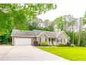 Attractive home has a lush lawn, side driveway, and an attached two car garage at 2430 Tribble Creek Cv, Grayson, GA 30017