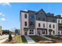 A contemporary townhome featuring a stylish brick facade and well-manicured landscaping at 449 Breccia Run, Mcdonough, GA 30253