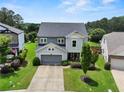 Beautiful two-story home featuring a well-manicured lawn and inviting covered front porch at 5730 Arbor Green Cir, Sugar Hill, GA 30518