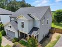 Side view of a lovely two-story home with a well-maintained lawn and mature landscaping at 5730 Arbor Green Cir, Sugar Hill, GA 30518