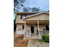 Two story exterior featuring a front porch at 1225 Creek Forest Nw Ct, Conyers, GA 30012