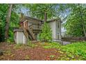 Back of home with stairs leading to a deck, partially surrounded by a wooden fence at 1478 Oxford Ne Rd, Atlanta, GA 30307