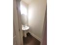 Cozy powder room with a pedestal sink and neutral paint, offering a functional design at 1942 Dillon Dr, Lithonia, GA 30058