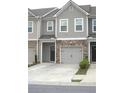 Attractive townhome exterior featuring a stone-accented garage and neutral color palette at 1942 Dillon Dr, Lithonia, GA 30058