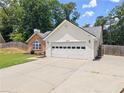 Charming single-story home featuring a brick facade, white siding, and a well-manicured lawn at 2605 Fort Apachee Trl, Dacula, GA 30019