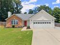 Charming single-story home featuring a brick facade, white siding, and a well-manicured lawn at 2605 Fort Apachee Trl, Dacula, GA 30019