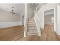Welcoming foyer featuring a staircase, elegant chandelier, wainscotting, and hardwood floors at 2870 Tattersall Ct, Cumming, GA 30041