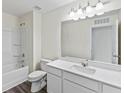 Bathroom features a tub, shower, and long vanity with wood-look vinyl floors at 1201 Fagiolo St, Mcdonough, GA 30253