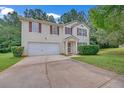 Traditional two-story home with a clean exterior, attached garage, and landscaped front yard at 7459 Old Chapel, South Fulton, GA 30349