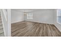 Open living area with hardwood flooring and large windows allowing ample natural light at 7459 Old Chapel, South Fulton, GA 30349