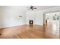 Expansive living room showcases hardwood flooring, a fireplace, and seamless transition to dining area at 626 Pecan Knoll Dr # 13, Marietta, GA 30008