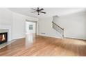 Spacious living room with hardwood floors, fireplace, staircase, and open access to the dining area at 626 Pecan Knoll Dr # 13, Marietta, GA 30008