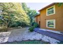 Exterior view of the home with a sprawling yard and mature trees at 838 Lake Hollow Sw Blvd, Marietta, GA 30064