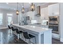 Bright, modern kitchen with stainless steel appliances, quartz countertops, and ample seating at the island at 1382 Doublegate Ne Dr, Atlanta, GA 30319
