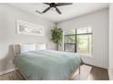 Bright bedroom with large windows, a ceiling fan and a minimalist aesthetic featuring a light wood frame bed at 19 Moda Ln, Atlanta, GA 30316