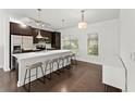 Bright kitchen boasts a large island with barstools, stainless steel appliances, and sleek cabinetry at 19 Moda Ln, Atlanta, GA 30316