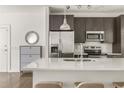 Modern kitchen with stainless steel appliances, a large island with seating and updated cabinetry and fixtures at 19 Moda Ln, Atlanta, GA 30316