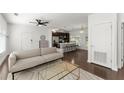 Open-concept living room with a modern sofa, stylish coffee table, and access to the kitchen at 19 Moda Ln, Atlanta, GA 30316