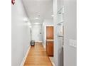 Hallway with hardwood floors, front door, and view to the kitchen with bar seating at 1253 Caroline Ne St # 223, Atlanta, GA 30307