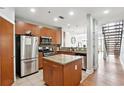 Open-concept kitchen featuring stainless steel appliances, granite countertops, and kitchen island at 1253 Caroline Ne St # 223, Atlanta, GA 30307