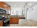 Modern kitchen with stainless steel appliances, granite counters, and views of the dining and living areas at 1253 Caroline Ne St # 223, Atlanta, GA 30307