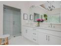Elegant bathroom features double vanity, large mirror, walk-in shower with glass door, and neutral colors at 2045 Bethany Spring Trce, Cumming, GA 30041